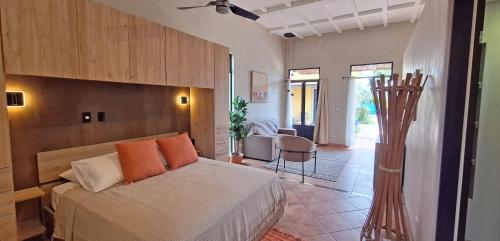 a bedroom with a bed with orange pillows on it at Club Heasa - Men Only in La Garita