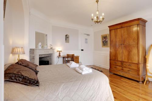 a bedroom with a large bed and a fireplace at Hattonchatel Château & Restaurant La Table du Château in Hattonchâtel