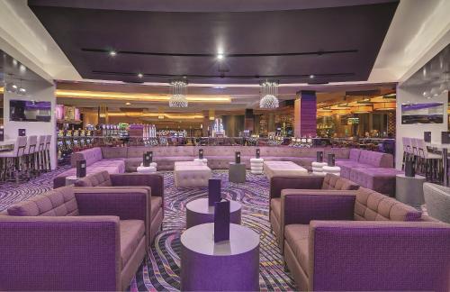 a lobby with purple couches and tables at MGM Grand Detroit in Detroit