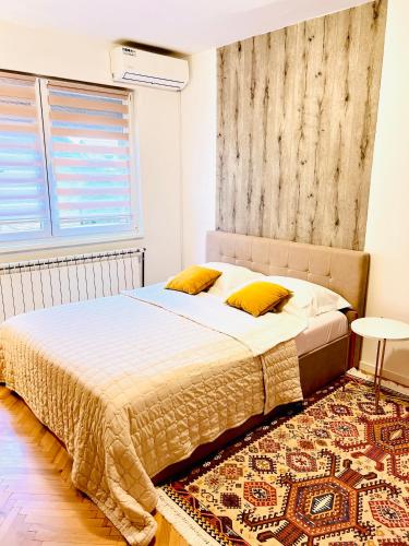 a bedroom with a bed and a rug at Guest House Bosnian House in Sarajevo