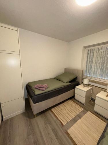 a small bedroom with a bed and a window at Fewo am Rammelsberg in Goslar