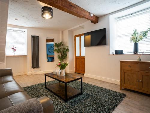 a living room with a couch and a coffee table at Garn View in Dolgellau