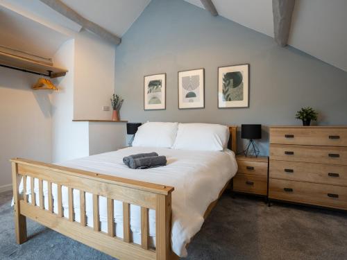 a bedroom with a large bed and a wooden dresser at Garn View in Dolgellau