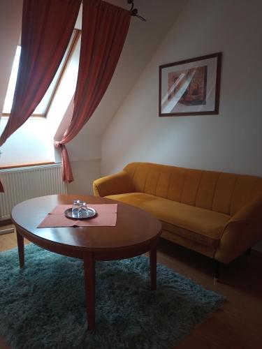 a living room with a couch and a coffee table at Penzion Scarlet in Trenčín