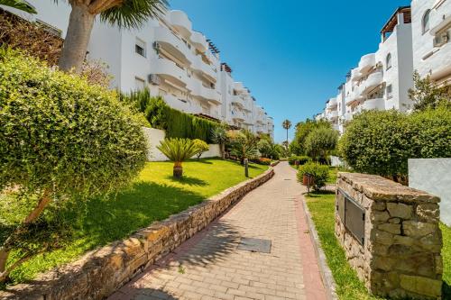 a brick path in front of a apartment building at Casa Nani in Zahara de los Atunes