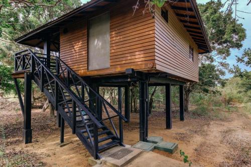 a tree house with a staircase leading up to it at Cinnamon Wild Yala in Yala