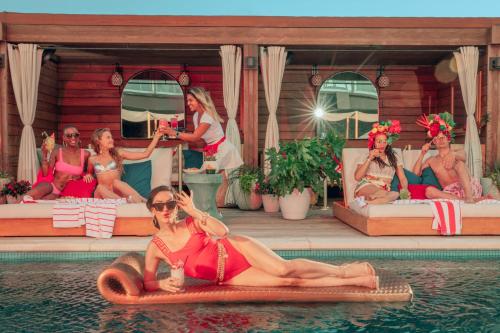 a woman in a red bikini laying on a raft in the water at Virgin Hotels Dallas in Dallas