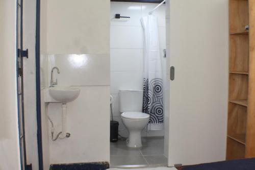 a bathroom with a toilet and a sink at Farfalla Guest House in Rio de Janeiro