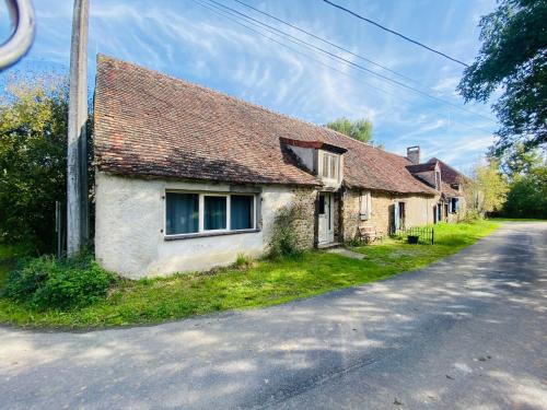 an old house on the side of a road at La Grange in Thollet