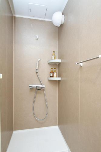 a bathroom with a shower with a shower head at M House Tokyo Omori駅 in Tokyo