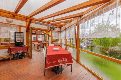 a dining room with a table and a window at Resort Abertham - penzion Ellen in Abertamy