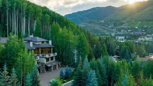 a house in the middle of a forest of trees at Alpenzauber Lodge in Vail