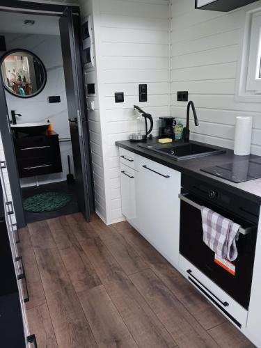 a kitchen with a sink and a stove at Relaxation in a Tiny House in Pernegg an der Mur
