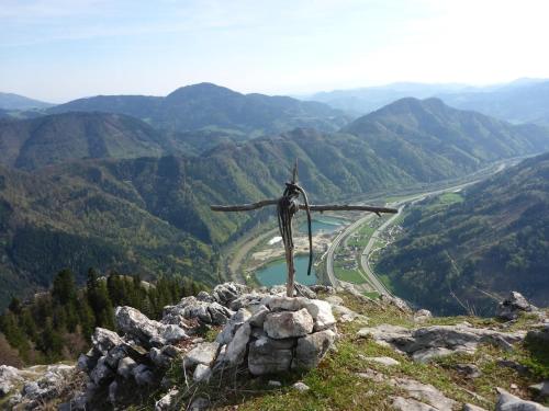 a wooden cross on the top of a mountain at Relaxation in a Tiny House in Pernegg an der Mur