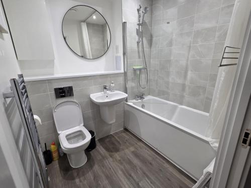 a bathroom with a sink and a toilet and a bath tub at Luxurious 3 Bed & 3 Bath Hatfield House with Balcony View & Terrace Garden in Smallford Station
