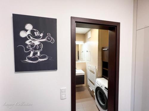 a drawing of a mickey mouse on a wall in a kitchen at Incredible Luxury Apt with Garage and Tram Station in Prague