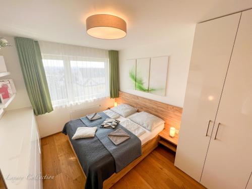a bedroom with a bed and a window at Incredible Luxury Apt with Garage and Tram Station in Prague