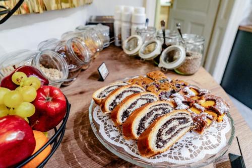 a table topped with a loaf of bread and fruit at Elisabeth Old Town in Bratislava
