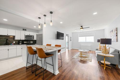 a white kitchen with a table and some chairs at Cozy Haven 2BR Condo 2207 Near Mart- Free Parking in Atlanta