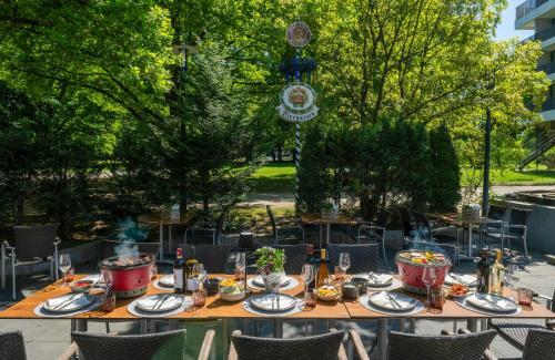 a table with food and drinks on top of it at Leonardo Hotel Hannover in Hannover