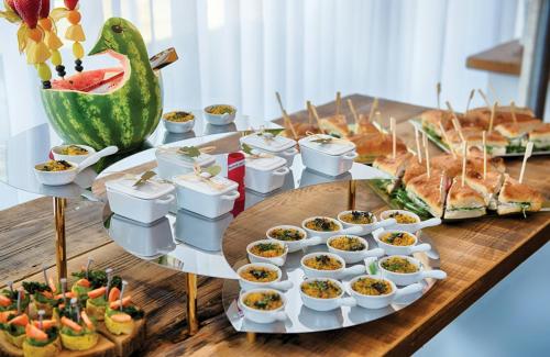 a table with a buffet of sandwiches and dips at Leonardo Hotel Hannover in Hannover