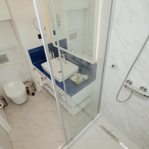 a bathroom with a shower and a sink and a toilet at ORBI CITY LUXURY deluxe KIG DVD in Batumi