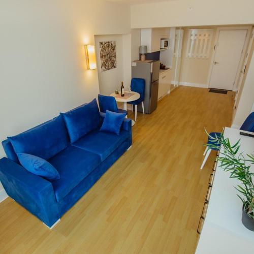 a living room with a blue couch and a table at ORBI CITY LUXURY deluxe KIG DVD in Batumi