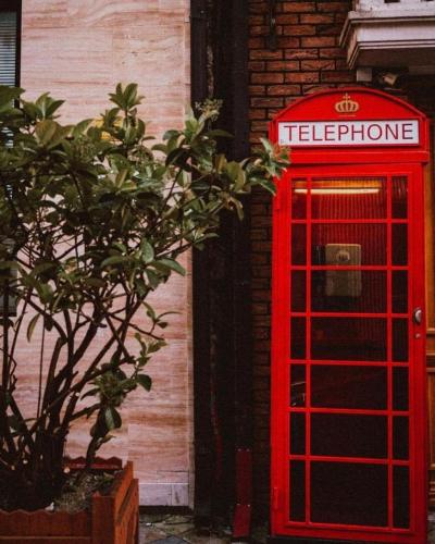 a red telephone booth in front of a building at ORBI CITY LUXURY deluxe KIG DVD in Batumi