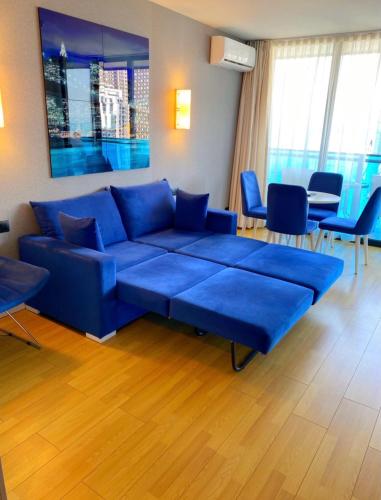 a living room with a blue couch and chairs at ORBI CITY LUXURY deluxe KIG DVD in Batumi