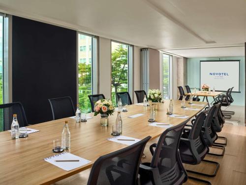 a large conference room with a long table and chairs at Novotel Living Saigon South in Ho Chi Minh City