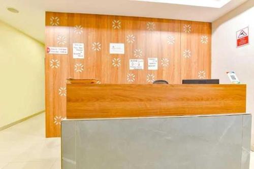 a wooden counter in a room with at Townhouse Oak Nani Daman in Daman