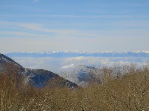 a view of a mountain range with trees and clouds at Hotel Sunny Shiga in Yamanouchi