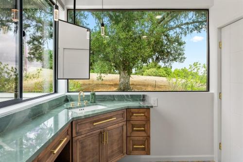 a bathroom with a sink and a large window at Mid-Mod Hilltop Retreat Views & Local Wildlife in Atascadero