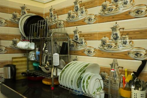 a kitchen counter with plates and dishes on a wall at Raindrop Homestay Havelock in Sir William Peel Island