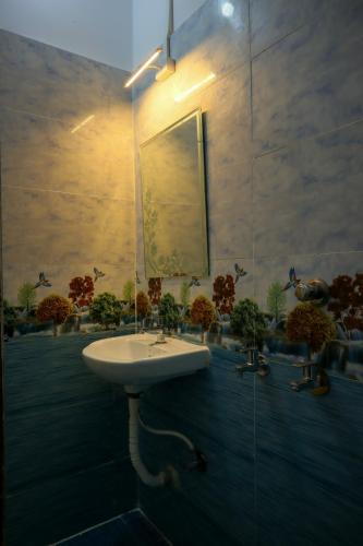 a bathroom with a sink and a mirror at Raindrop Homestay Havelock in Sir William Peel Island
