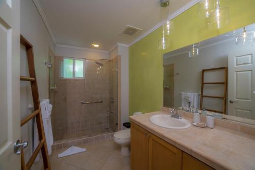 a bathroom with a sink and a shower and a toilet at Del Mar 4N 3 bdr Garden View in Los Suenos in Herradura