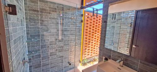 a bathroom with a glass shower and a sink at Club Heasa - Men Only in La Garita