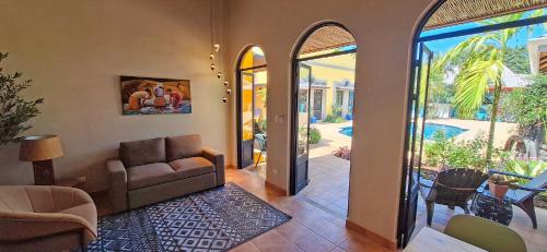 a living room with a couch and an open door at Club Heasa - Men Only in La Garita