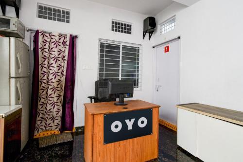a sign on a podium in a room with a tv at Hotel O Sun Lodge in Hyderabad