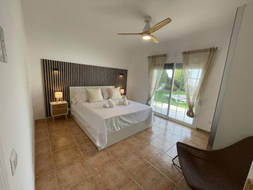 a bedroom with a bed and a ceiling fan at Charming villa in Nerja in Nerja