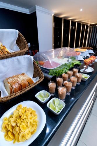 a buffet line with food on a table at Hotel Plaza Monte Carlo in Guayaquil