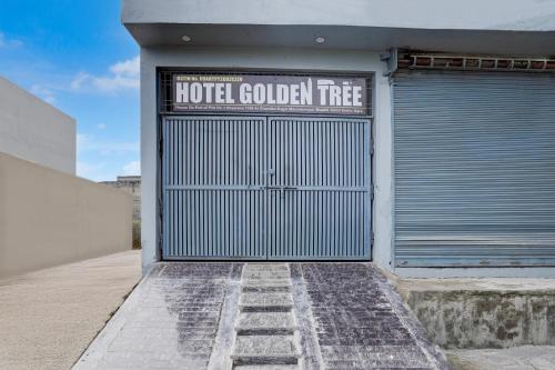 a metal garage door with a hotel golden tree sign on it at SPOT ON Hotel Golden Tree in Agra