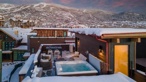 a hot tub on the roof of a house in the snow at Borough House in Steamboat Springs
