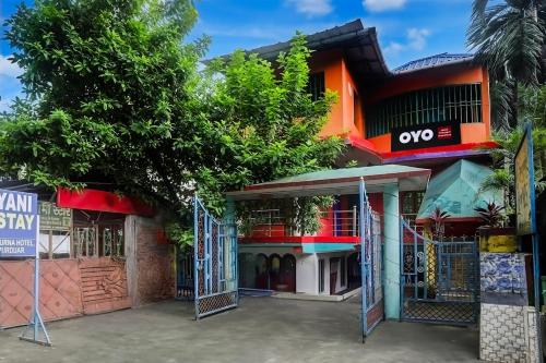 a building with a gate in front of it at Hotel O Trinayani Homestay in Mādāri Hāt
