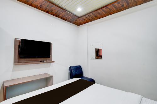 a bedroom with a bed and a flat screen tv at HOTEL O DEVARA GRAND in Maula Ali