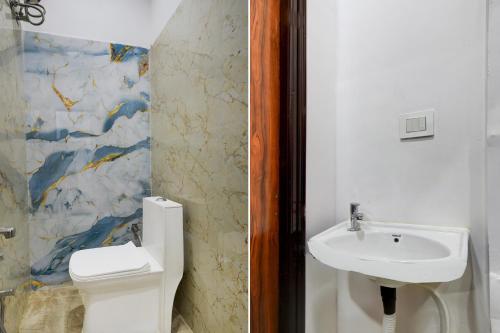 a bathroom with a toilet and a sink at HOTEL O DEVARA GRAND in Maula Ali