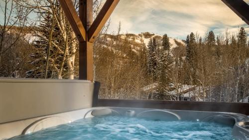 a hot tub with a view of a snowy mountain at Brown Bear Chalet in Steamboat Springs