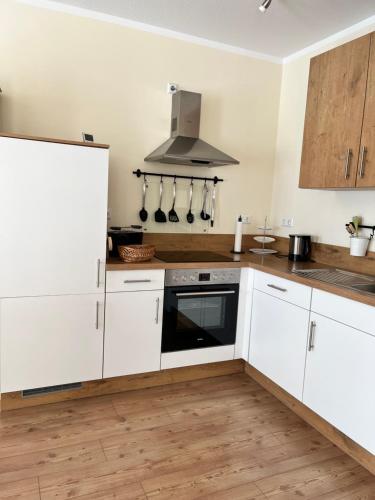 a kitchen with white cabinets and a stove at Alte Heimat in Schwegenheim