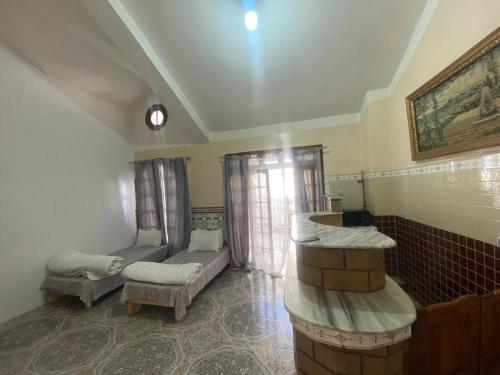 a living room with a couch and a table at Family Lounge in Matriouene