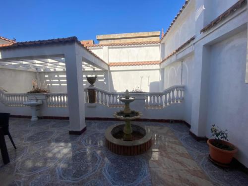 a courtyard with a fountain in the middle of a building at Family Lounge in Matriouene